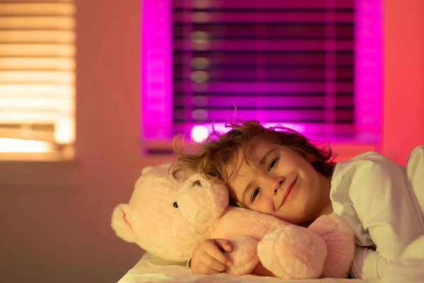 Child cannot sleep on bed at night in bedroom. Kid having sleeplessness. Kid boy sleeping in bed with night light