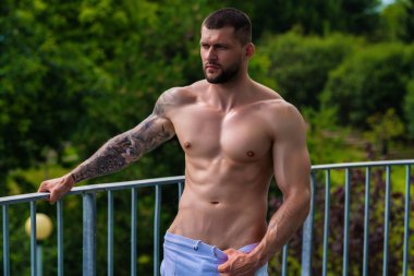 Muscular men lifting weights. Powerful male fit model doing workout in gym. Man lifting dumbells, strong athletic fit man doing exercises with dumbbells. Weightlifting workout. Fitness workout
