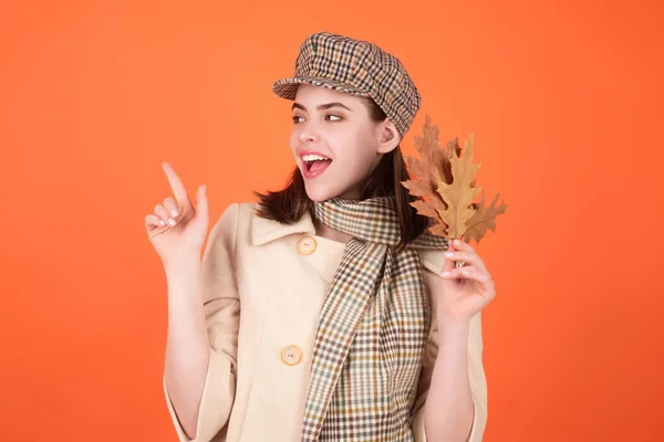 stock image Autumn portrait woman with fall maple leaves on studio isolated background with copy space. Autumn portrait of cheerful woman with fall leaves wearing beret hat and autumn warm scarf