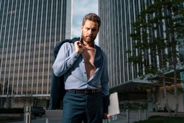 Attractive man in shirt. Sexy businessman outdoors. Portrait of a mature strong businessman. Businessman walking. Businessman in front of office. Business portrait of serious business man clipart