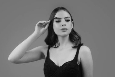 Womans eyebrows. Beautiful girl with eyebrow brush. Girl with natural make up. Eyebrow correction