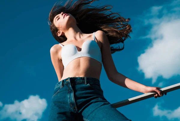 stock image Denim fashion. Sexy girl in blue jeans over sky background. Womens Jeans. Fashion season. Casual vogue