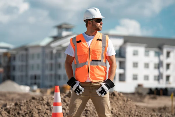 建筑建筑工人在建筑物建筑背景上穿着制服 建筑工地的建筑商 建筑工地上戴头盔的男工 戴硬礼帽的硬汉 — 图库照片