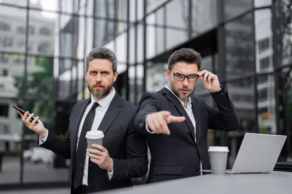 stock image Expression face of emotional business man. Serious businessman pointing finger on you. Portrait of businessman in suit outdoor. Collaboration to the success of the two business team