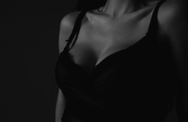 Women with sexy breas, boobs in bra, sensual tits. Beautiful slim female body. Lingerie model. Closeup of sexy female boob in black bra
