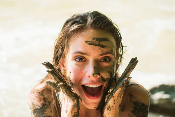 stock image Smiling girl with mud mask. Muddy hands. Woman with natural mud mask