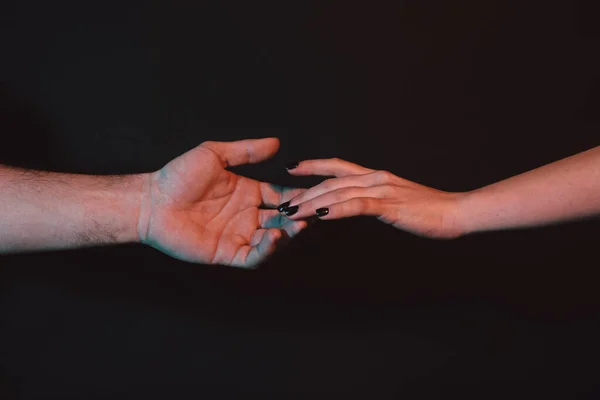 Reaching touching hands. Reach hand. Hopeful concept. Two hands trying to touch. Adam sign. Human relation, togetherness. Hands of man and woman reaching to each other. Hand try to touch