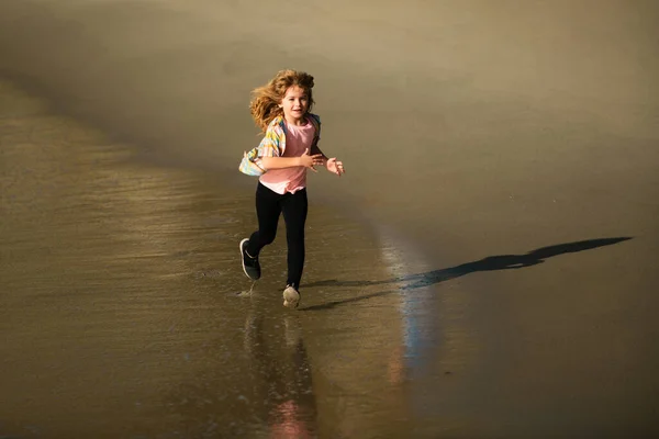子供は海辺を走る ビーチで走っている子供たち 夏休みだ ビーチで遊んでいる幸せな少年 幸せな子供時代 子供のためのランニングと健康的なスポーツ — ストック写真