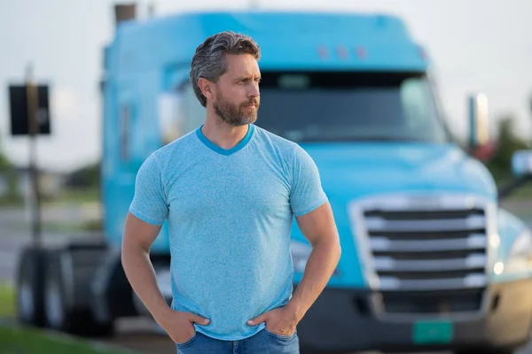 Men driver near lorry truck. Man owner truck driver. Millennial trucker. Trucking owner. Transportation industry vehicles. Handsome man posing in front of truck