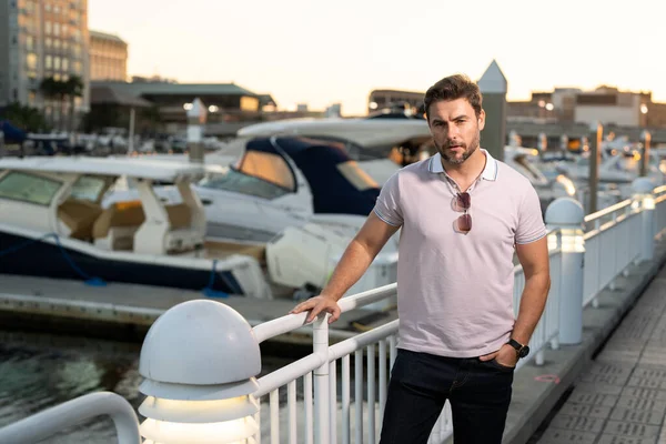 stock image Portrait of handsome confident man in city. Portrait of confident man in modern big american city. Stylish lambersexual model. Sexy man dressed in polo. Fashion male posing on street in Tampa