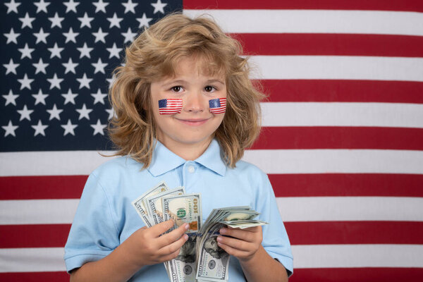 American dollars money banknotes concept. Rich kid with dollars. Lottery cashback, win big money isolated on studio background. Independence day 4th of july. Child with american flag