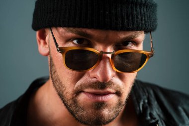 Seksi bir adamın baştan çıkarıcı yüzü. Maço kendinden emin görünüyor. Ciddi profil yüzlü bir adamın yakın portresi.