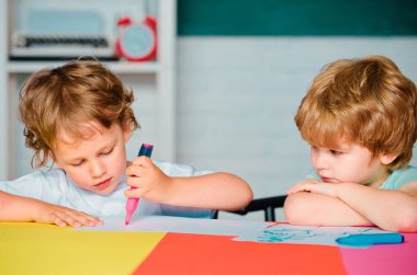 Back to school. Children at the blackboard. Kids with a book. Cute little boys pupils with cute study