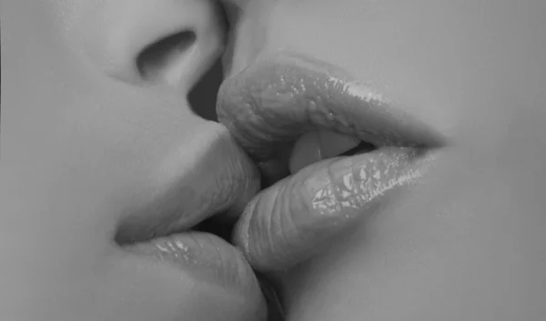 Two lesbian friends kissing. Sensual lips kisses. Passion and sensual touch