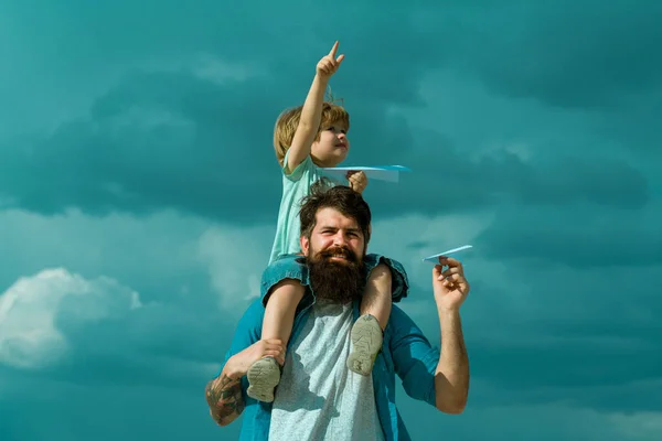 父亲节快乐爸爸和儿子在天空背景下玩耍 小孩坐在他父亲的肩上 想象力 爸爸和他儿子的孩子在户外玩耍 — 图库照片