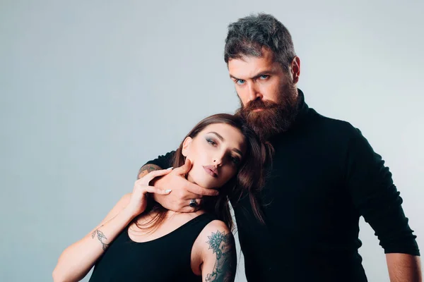 stock image hairdresser and barbershop. tattoo salon. male beard care. hipster man with sexy girl. relationship. fashion couple. couple in love. brutal bearded man and woman with tattoo. hipster couple.