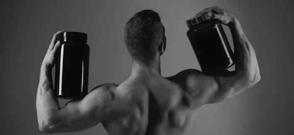 Dieta Witaminowa Odżywki Sportowe Silny Człowiek Trzymać Butelki Suplementu Muskularny — Zdjęcie stockowe