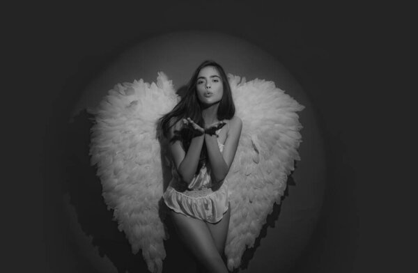 Valentines Day concept. Cupid woman. Valentines Day symbol. Angel woman with feather white wings and gift