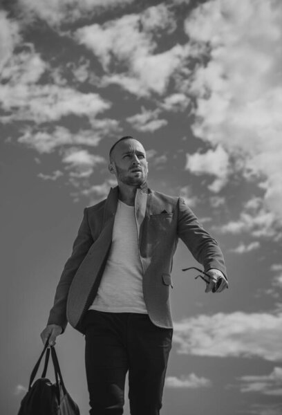 Charming man with sunglasses. Casual urban style. Serious face