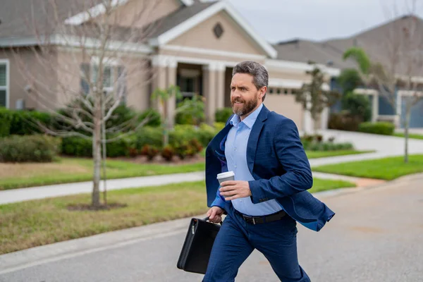 Business man with briefcase and take away coffee run outdoor. Businessman run down street, late meeting. Running business man. Fast business. Run and late business. Manager ceo run from home