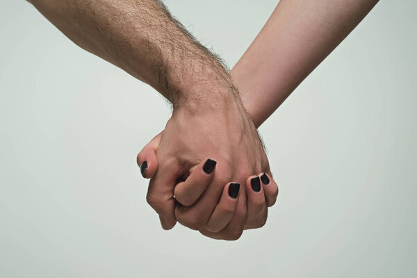 Helping hand. Holding hand, close up. Giving a helping hand. Rescue, helping gesture or hands. Salvation relations. Help hand gesture, sign of help and hope. Helping arm, charity