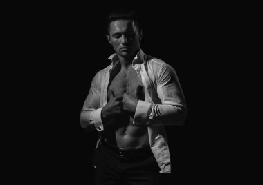 Yakışıklı, genç bir adam soyunuyor. Moda adamı. Çıplak vücut, çıplak gövde.