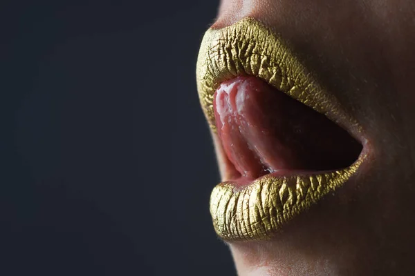 Sexy tongue licking lips. Golden glitter lipstick. Shine style for sexy lip. Sensual woman lips. Luxury golden mouth. Glamour gold lips. Golden lips with golden paint or metallic lipstick