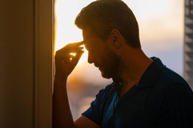 Tired man having a terrible headache. Exhausted man feeling unhealthy, upset about headache illness. Closeup portrait of stressed middle-aged man having headache. Migraine and headache concept clipart