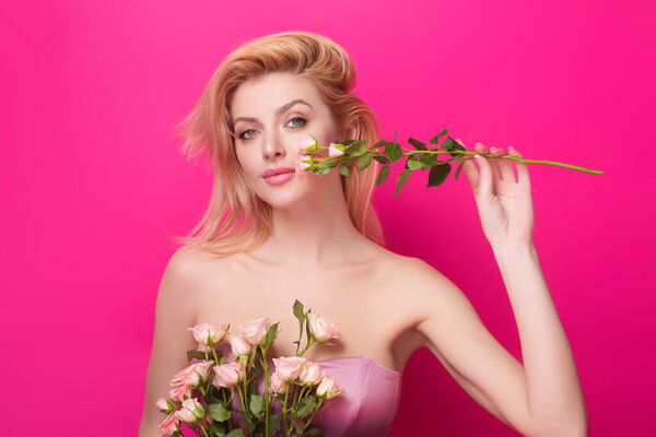 Valentines Day. Slim sexy beautiful woman with naked shoulder hold red roses, isolated on studio background. Portrait of sensual girl with flowers
