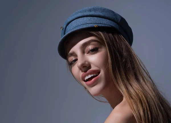 Sexy attractive woman posing with cap. Beautiful sexy model portrait. Beauty woman face. Attractive sensual girl with fashion hat, close up