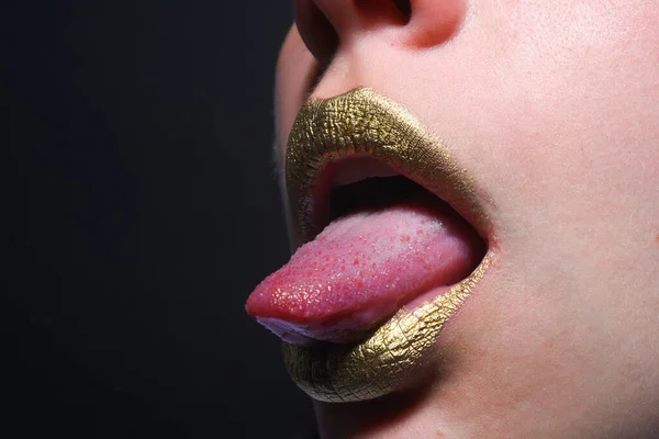 Lip icon with golden glitter effect. Sensual mouth. Symbol of kiss from golden lipstick. Glamour luxury gold mouth. Gold paint on lips. Golden lips, sensual woman mouth. Metallic body. Gold concept