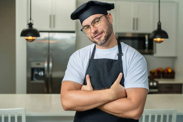 Man chef cooker baker. Millennial male chef in chefs uniform. Chef man cooking on kitchen. Chef cook in hat and apron