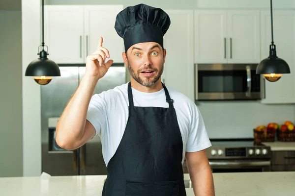 Portrait of chef, cooks or baker. Man in cook hat and chef uniform cooking on kitchen