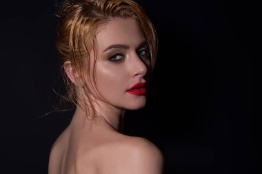 Beauty face of young blonde woman. Sexy model posing in studio. Portrait of beautiful girl. Beauty woman face closeup. Pretty girl face on studio background. Sensual look. Beautiful female face