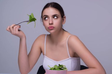 Vegetables diet. Young woman eating healthy food, dieting. Girl eating vegetable diet salad in studio. Vegan salad. Female on diet. Dieting concept. Healthy lifestyle. Diet for weight loss