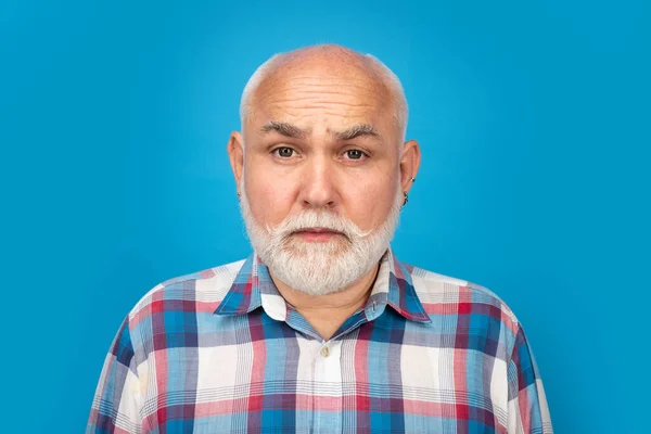 Closeup emotional portrait of an old mature senior man with grey beard isolated on studio background. Emotions sad faces
