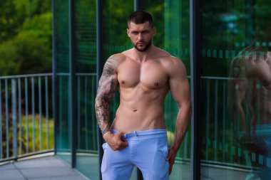 Man exercising with dumbbell. Male bodybuilder doing weight lifting workout at gym. Training with barbell. Muscled man strong muscular fit man workout with heavy weight. Exercises for muscular body