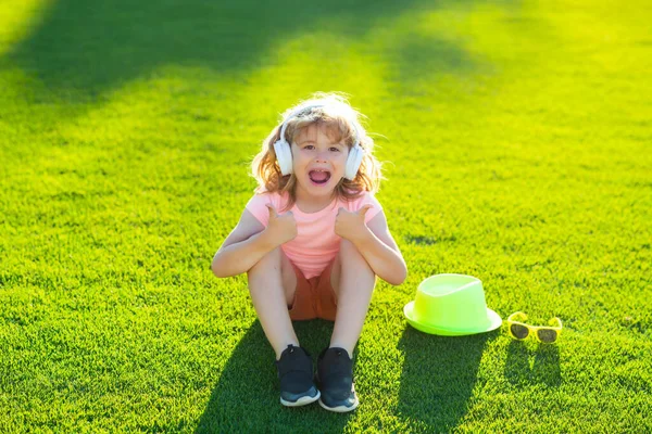 stock image Young child boy with headphones listening to music outdoor