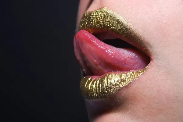 Sexy gold lips, golden lipgloss on sexy lips, metallic mouth. Sensual woman mouth. Sexy girl golden lips, gold mouth. Glowing gold skin and gild lips. Metallic shine golden lip gloss