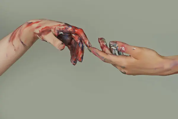 Painted hands. Reach hand. Sensual touch fingers. Two hands trying to touch. Adam sign. Human relation, togetherness. Hands of man and woman reaching to each other. Hand try to touch