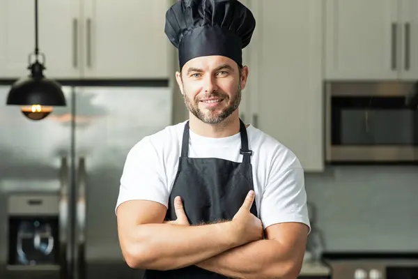 Handsome middle age man in chef uniform at kitchen. Cooking and culinary. Restaurant menu concept. Catering and cooking, advertising food concept. Man chef in uniform in kitchen