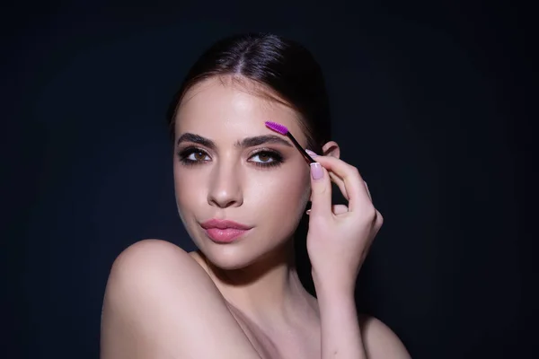 Beautiful woman with perfect shape eyebrows. Womans brows close up. Beautiful girl with eyebrow brush. Eyebrow correction. Long eyelashes and thick eyebrows