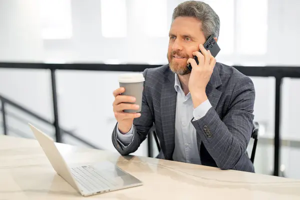 Manager, ceo talk on phone in suit in office. Office worker using phone, office call center. Man talk on phone. Business man have business call, talking on phone. Office interior
