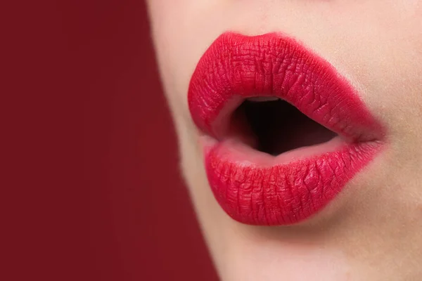 Close up woman applying red lipstick on lips. Sexy girl applied lipstick. Red lips lipstick make up. Putting lipstick on lips