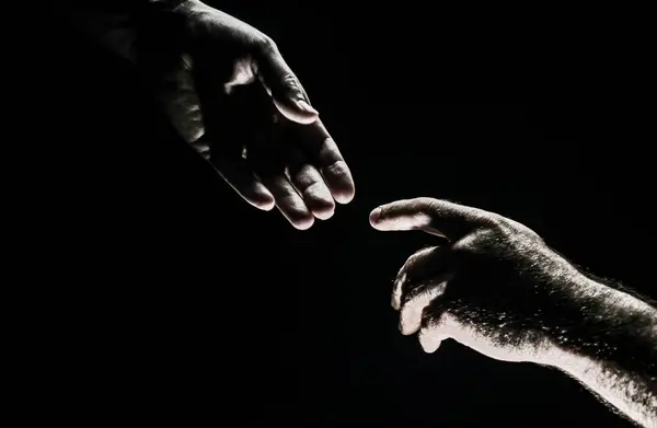 Men holding hands isolated on black. Connection and human relations. Male hands rescue. Friendly handshake, friends greeting, friendship. Rescue, helping gesture or hands. Helping hand. Hand creation