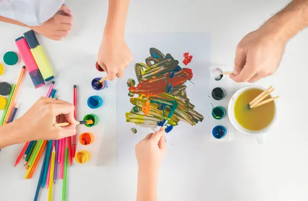 Humans hand is drawing with colorful pencils.