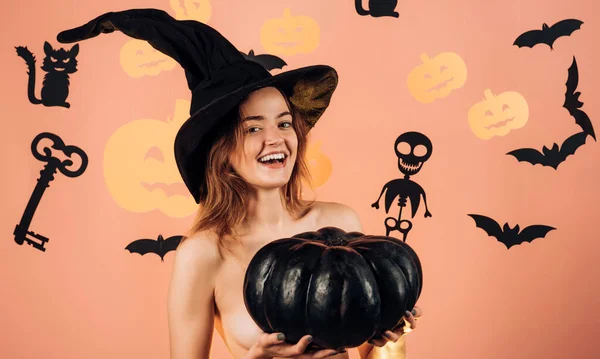 Trick or treat. Witch hat. Magic pumpkin. Girl play with pumpkins and treat. Best ideas for Halloween. Secrets of Magic for Happy Halloween