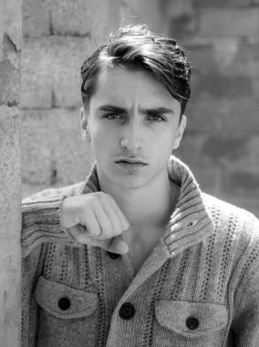 Serious face. Portrait of self confident man. Close-up of young man against grey background. Mens fashion concept