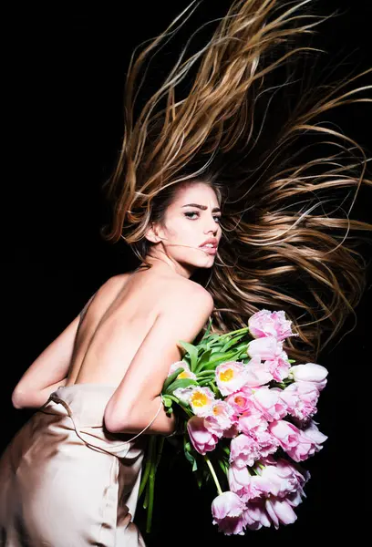 Sexy girl with the flowers. Florist advert. Fashion haircut, vogue hairstyle