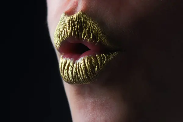 Kiss. Sexy gold lips, golden lipgloss on sexy lips, metallic mouth. Sensual woman mouth. Sexy girl golden lips, gold mouth. Glowing gold skin and gild lips. Metallic shine golden lip gloss